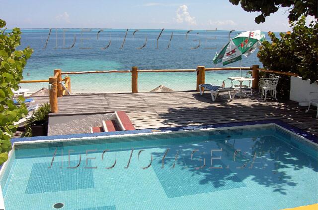 Mexique Cancun Maya Caribe Some chairs and umbrellas around the pools. The pool in the middle with a small terrace.