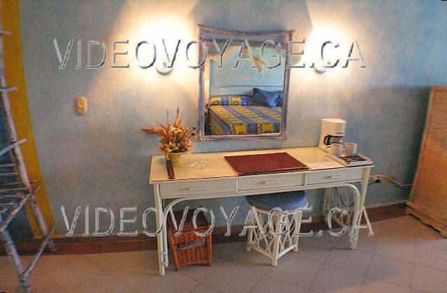 Cuba Cayo Guillermo Sol Cayo Guillermo A small desk with a coffee maker, a mirror and a small bench. On this wall, all electrical outlets are used by electrical equipment.