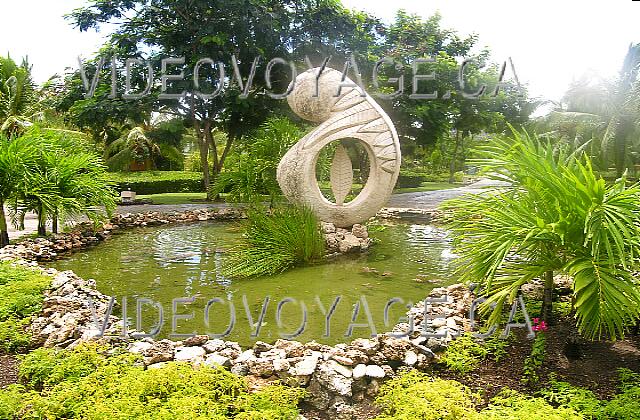 Cuba Guardalavaca Paradisus Rio de oro Many statues integrated with abundant vegetation.