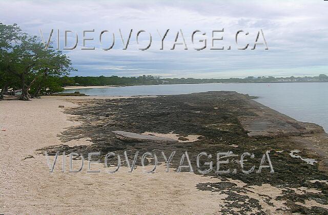 Cuba Guardalavaca Playa Pesquero The beach is divided in two by a rock with an ancient foundation for a building.