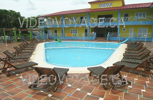 Cuba Guardalavaca Memories Holguin Beach Resort Sun loungers miniature goshawks the pool.