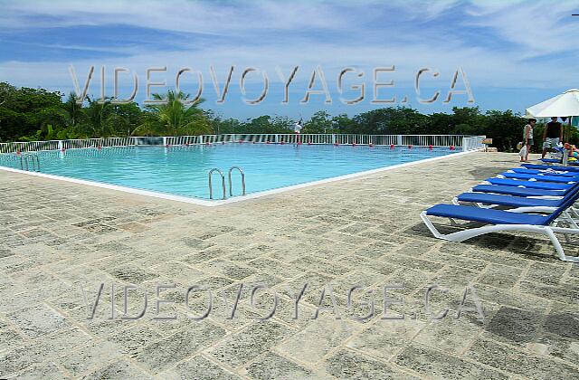 Cuba Guardalavaca Memories Holguin Beach Resort Des chaises longues recouvertent de tissus et quelques parasols.