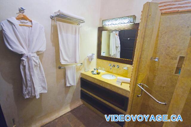 Maroc Bin El Ouidan Widiane Suites & Spa The bathroom, a small counter with a sink, bathrobe ...