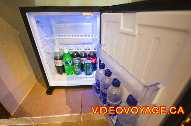 Republique Dominicaine Punta Cana Punta Cana Refrigerator with several bottles of water, soft drinks and beer.