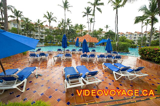 Republique Dominicaine Punta Cana Punta Cana Parasols and sun loungers on the terrace between the pool bar and beach restaurant.