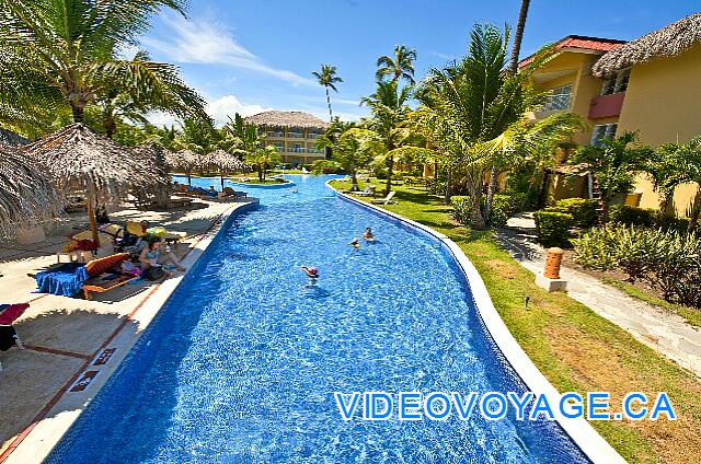 République Dominicaine Punta Cana Dreams Punta Cana Muchos palapas y tumbonas en la terraza en el lado sur de la piscina, el otro lado de la piscina es el pequeño campo fuera de las habitaciones.