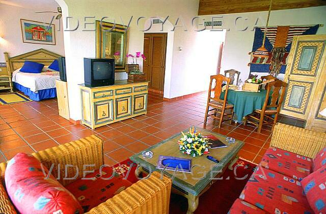 Republique Dominicaine Punta Cana Occidental Grand Punta Cana La chambre du Club Royal est grande.  Le grand salon est composé d'une table et d'un saufa.  Un téléviseur est disponible dans le salon et la chambre.