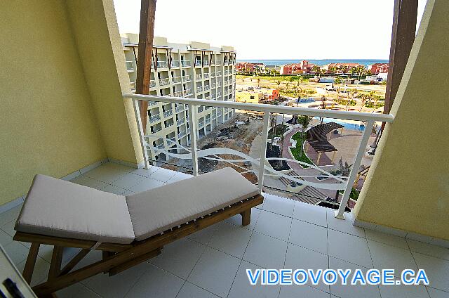 Cuba Varadero Melia Marina Varadero A long balcony with sun loungers, two chairs and a table.