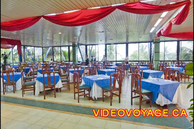 Cuba Varadero Bellevue Puntarena Playa Caleta Resort The dining room of medium size with large windows that can see the sunset.