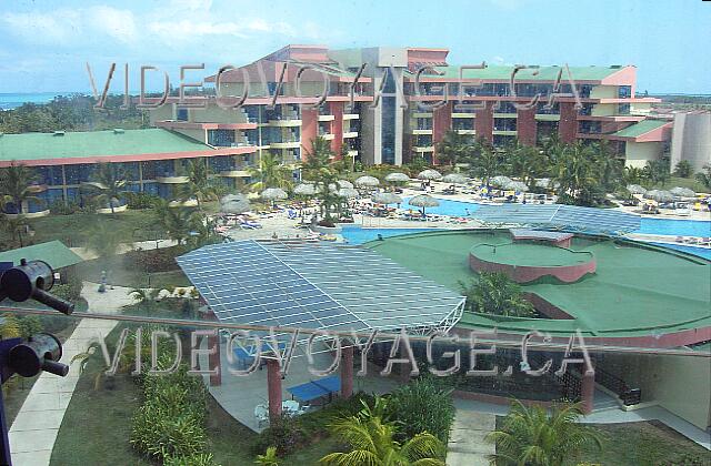 Cuba Varadero Mercure Playa De Oro A view from the panoramic elevator. The rooms are in two buildings shaped halfpipe The pool at the site center. In the bar pool bar.