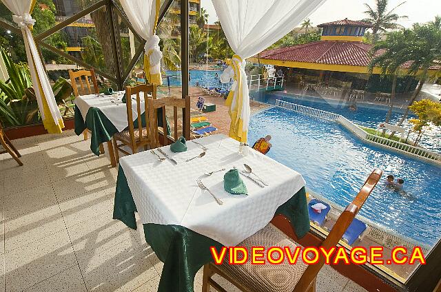 Cuba Varadero Hotel Villa Cuba Some tables on the edge of the windows with a view of the pool.